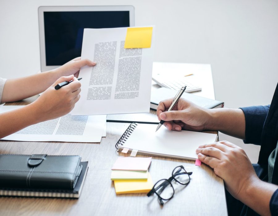 Two high school students campus or classmates with helps friend studying for a test an exam in workbook learning in classroom, Tutor books with friends, Education school concept.